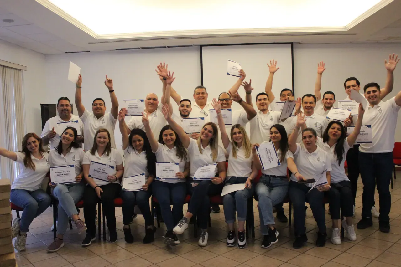 Equipo celebrando al finalizar una dinámica, reflejando la satisfacción y la energía del trabajo colaborativo