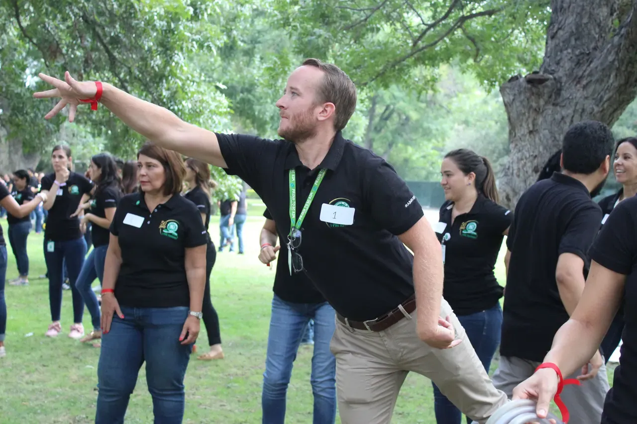 Profesor sonriente celebrando al completar un desafío grupal, destacando la energía positiva de las actividades de integración